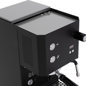 Close-up of a black espresso machine showing the side panel, front controls, steam wand, and portafilter against a white background.