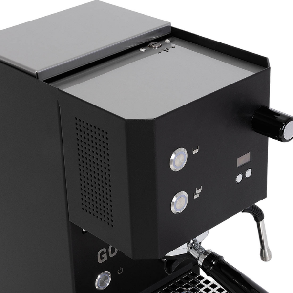 Close-up of a black espresso machine showing the side panel, front controls, steam wand, and portafilter against a white background.