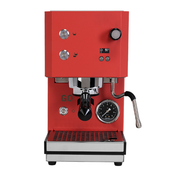 A red and stainless steel espresso machine with a portafilter, steam wand, pressure gauge, and drip tray, shown against a plain white background.