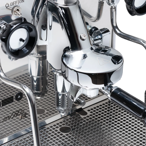 Close-up of a shiny metal espresso machine with visible brand name.