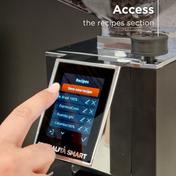 Hand using a digital display on a coffee grinder with 'Access the recipes section' text.