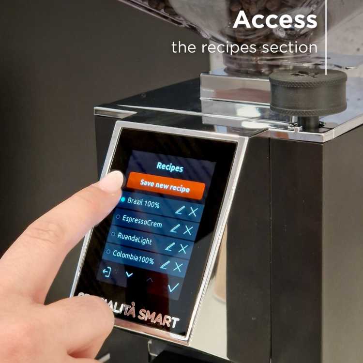 Hand using a digital display on a coffee grinder with 'Access the recipes section' text.